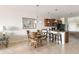 Cozy dining area with pendant lighting adjacent to a kitchen with island seating at 19241 Serafina St, Venice, FL 34293