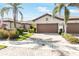 Charming single-story home featuring a well-manicured lawn, mature landscaping, and a spacious driveway leading to a two-car garage at 19241 Serafina St, Venice, FL 34293