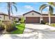 Inviting single-story home featuring a well-manicured lawn, mature landscaping, and a spacious driveway leading to a two-car garage at 19241 Serafina St, Venice, FL 34293