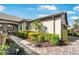 Landscaped front yard featuring mature plants, mulch beds, and a brick walkway leading to the front porch at 19241 Serafina St, Venice, FL 34293