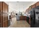 Open kitchen boasts stainless steel appliances, spacious layout, and seamless flow to the living area at 19241 Serafina St, Venice, FL 34293