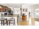 Kitchen has an island with seating and ample natural light, leading to the entryway at 19241 Serafina St, Venice, FL 34293