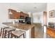 Kitchen features a granite countertop island with seating and stainless steel appliances at 19241 Serafina St, Venice, FL 34293