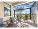 Screened patio overlooking a serene pond and lush landscaping at 19241 Serafina St, Venice, FL 34293