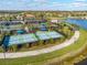 Overhead view of the tennis courts and scenic landscaping, perfect for outdoor enthusiasts at 19241 Serafina St, Venice, FL 34293