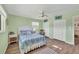 Comfortable bedroom with hardwood floors, ceiling fan, white trim, and ample closet space at 1960 Mississippi Ave, Englewood, FL 34224