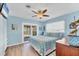 Comfortable bedroom with a ceiling fan, sliding glass doors, and an ample supply of natural light at 1960 Mississippi Ave, Englewood, FL 34224