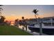 Dock and boat lift with views of the serene canal at sunset; ready for boating enthusiasts at 1960 Mississippi Ave, Englewood, FL 34224