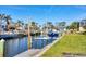 Private boat dock with boat lift and waterfront access on a sunny day at 1960 Mississippi Ave, Englewood, FL 34224