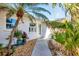 Charming front entrance with lush tropical landscaping and a welcoming pathway at 1960 Mississippi Ave, Englewood, FL 34224