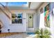 Charming front entrance with tropical decor and a welcoming, covered entryway at 1960 Mississippi Ave, Englewood, FL 34224