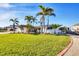 Inviting single-story home with mature palm trees and well-maintained lawn at 1960 Mississippi Ave, Englewood, FL 34224