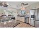Well-lit kitchen featuring granite counters, tile backsplash, stainless steel appliances and light wood cabinets at 1960 Mississippi Ave, Englewood, FL 34224