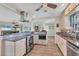Open concept kitchen with granite countertops, stainless steel oven and a breakfast bar overlooking living area at 1960 Mississippi Ave, Englewood, FL 34224
