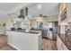 Modern kitchen with granite countertops, stainless steel appliances, and ample cabinet space for storage at 1960 Mississippi Ave, Englewood, FL 34224