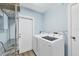 Functional laundry room with modern appliances, ample storage space, and convenient access at 1960 Mississippi Ave, Englewood, FL 34224