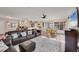 Inviting living room with wood floors, comfortable seating, and an open layout to the kitchen and dining area at 1960 Mississippi Ave, Englewood, FL 34224