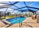 A dazzling, covered pool with clear blue water and ample room for outdoor seating at 1960 Mississippi Ave, Englewood, FL 34224