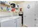 Functional laundry room with appliances, shelving, and storage solutions at 20061 Ragazza Cir # 101, Venice, FL 34293