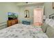 This comfortable bedroom features a ceiling fan, natural light, and a TV with a view at 20110 Ragazza Cir # 102, Venice, FL 34293