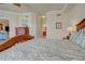 Comfortable bedroom with a bed, dresser, and an ensuite bathroom, providing lots of natural light at 20110 Ragazza Cir # 102, Venice, FL 34293