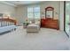 Bedroom featuring a chair, dresser, window with blinds, and ample natural light at 20110 Ragazza Cir # 102, Venice, FL 34293