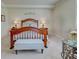 Bedroom with decorative headboard, bench and side table, with lots of natural light at 20110 Ragazza Cir # 102, Venice, FL 34293
