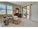 Bedroom featuring a chair, dresser, and a large window with a view of the outdoors at 20110 Ragazza Cir # 102, Venice, FL 34293