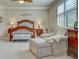 Cozy bedroom suite showcasing a well-lit sitting area and a king-sized bed at 20110 Ragazza Cir # 102, Venice, FL 34293