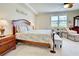 Spacious bedroom with a bed, dresser, chair, and a well-lit atmosphere at 20110 Ragazza Cir # 102, Venice, FL 34293