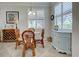 Bright dining nook with rattan chairs, a glass table, and natural light from the window at 20110 Ragazza Cir # 102, Venice, FL 34293