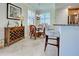 Charming breakfast nook with rattan chairs, a glass table, and a cozy, well-lit ambiance at 20110 Ragazza Cir # 102, Venice, FL 34293