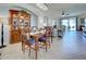 Dining area with a wooden table, hutch, and comfortable seating adjacent to living area at 20110 Ragazza Cir # 102, Venice, FL 34293