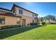 Well-maintained townhome exterior featuring lush green lawn and manicured shrubbery at 20110 Ragazza Cir # 102, Venice, FL 34293
