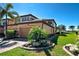 Charming two-story townhome with a tile roof, attached garage, and lush landscaping at 20110 Ragazza Cir # 102, Venice, FL 34293