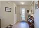 Warm and inviting foyer with tile flooring, decorative mirror, and stylish console table at 20110 Ragazza Cir # 102, Venice, FL 34293