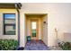 Inviting front entry with brick pavers, decorative plants, and glass paneled front door at 20110 Ragazza Cir # 102, Venice, FL 34293