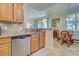 The kitchen features stainless steel appliances, granite countertops, and light wood cabinetry, next to the breakfast nook at 20110 Ragazza Cir # 102, Venice, FL 34293