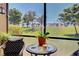 Inviting screened lanai with relaxing seating, showcasing picturesque golf course views and lush landscaping at 20110 Ragazza Cir # 102, Venice, FL 34293