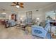 Comfortable living room with light blue leather furniture, decorative ceiling fan, and classic built-in cabinet at 20110 Ragazza # 102, Venice, FL 34293