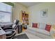 A well-organized office features a wooden desk, comfortable seating, storage, and decor for a productive workspace at 20110 Ragazza Cir # 102, Venice, FL 34293