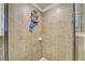 Tiled shower featuring storage fixtures, a handheld showerhead, and a glass enclosure at 20110 Ragazza Cir # 102, Venice, FL 34293