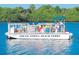 The South Venice Beach Ferry boat cruising on the water, offering passengers a unique and enjoyable beach access experience at 20110 Ragazza Cir # 102, Venice, FL 34293