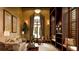 Cozy living room with bookshelves, sofa, accent chairs, curtains, and decor at 20110 Ragazza Cir # 102, Venice, FL 34293