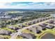 An aerial view showcases homes in a waterfront community with lush landscaping and lake views at 2088 Bonito Way, Port Charlotte, FL 33953