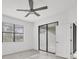 Bedroom with a ceiling fan, natural light, and a sliding glass door to the outdoor space at 2088 Bonito Way, Port Charlotte, FL 33953