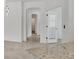 Hallway view featuring an arched entryway, light-colored walls and tile flooring at 2088 Bonito Way, Port Charlotte, FL 33953