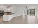 Spacious living area with tiled floors, ceiling fan, and sliding glass doors to the patio at 2088 Bonito Way, Port Charlotte, FL 33953