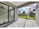 Covered outdoor patio, screened in, with pavers, fan, and sliding glass door at 2088 Bonito Way, Port Charlotte, FL 33953