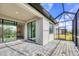 View of a covered and screened-in outdoor patio with a sliding glass door at 2088 Bonito Way, Port Charlotte, FL 33953